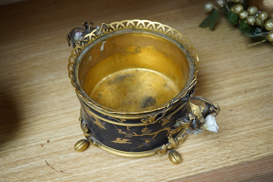 A French ormolu and lacquered jardiniere with porcelain mounted handles, stamped 'Bointaburet A Paris', together with a ‘pear’ candle display. Jardiniere width 23cm. Condition - one handle damaged, interior rubbed